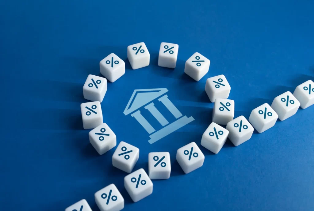 A blue table with a banking icon surrounded by dice with percent character